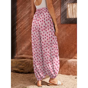 May include: Pink and white printed wide-leg pants with an elastic waistband.