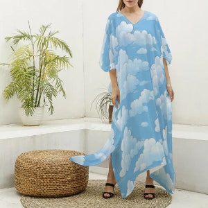 May include: A light blue maxi dress with a white cloud print. The dress has a V-neckline and a flowing silhouette.