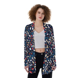 May include: A blue cardigan with a colorful book print. The cardigan has a long sleeve and a relaxed fit.