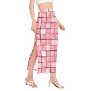 May include: A pink and white plaid midi skirt with a side slit. The skirt has a high waist and a fitted silhouette.