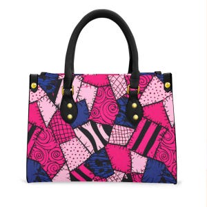 May include: A patchwork handbag with a black handle and accents. The bag features a vibrant pattern of pink, blue, and white patches with various designs, including swirls, stripes, and dots. Gold-coloured studs secure the handle to the bag.