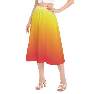 May include: A yellow to red ombre midi skirt with a high waist and a flowy silhouette.