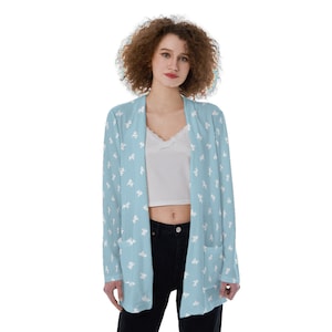 May include: A light blue cardigan with a white star pattern. The cardigan has long sleeves and a relaxed fit.