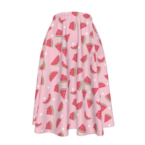 May include: A pink skirt with a watermelon print. The skirt features a white polka dot pattern and is made from a soft, comfortable fabric.