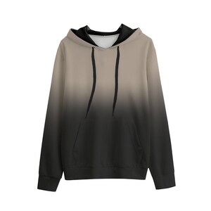 May include: A hooded sweatshirt with a gradient design, transitioning from tan at the top to black at the bottom. The hoodie features a front pocket, black drawstrings, and black lining inside the hood.