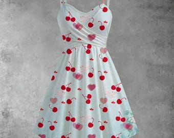 May include: A light blue sundress with a cherry and heart pattern. The dress has a sweetheart neckline, spaghetti straps, and a flared skirt. Red cherries and pink hearts are scattered across the fabric.