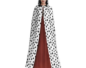 May include: A white hooded cape with black polka dots. The cape is long and flowing, and the hood is lined with black fabric.