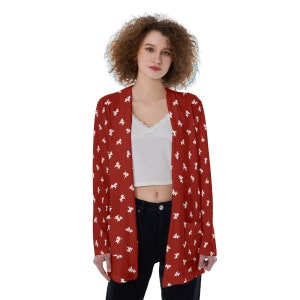 May include: A red cardigan with a white floral pattern. The cardigan has a long sleeve and a relaxed fit.