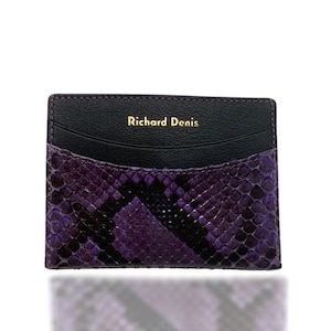 May include: A purple and black snakeskin card holder with a black leather interior and the text "Richard Denis" embossed in gold.