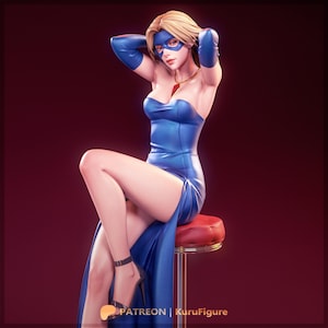 Puede incluir: Figura de una mujer con vestido, guantes y máscara azules, sentada en un taburete rojo. La figura tiene el pelo rubio y lleva tacones negros. Se ve un collar dorado con un colgante rojo. La imagen tiene el texto "PATREON | KuruFigure".