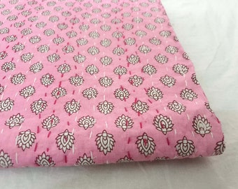May include: Pink cotton fabric with a white floral pattern. The fabric has a subtle sheen and a soft texture.