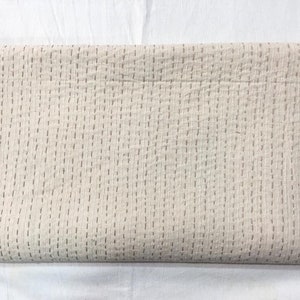 May include: A white kantha quilt with a subtle brown stitching pattern. The quilt is made of cotton and has a soft, lightweight feel.