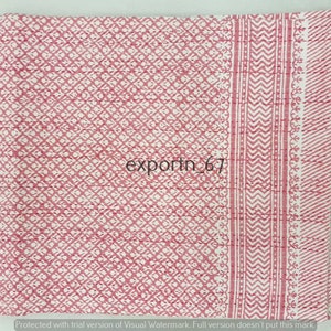 May include: A pink and white kantha quilt with a geometric pattern. The quilt has a border with a chevron pattern.