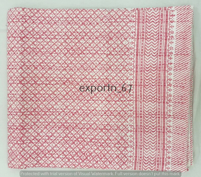 May include: A pink and white kantha quilt with a geometric pattern. The quilt has a border with a chevron pattern.
