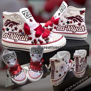 May include: White high-top sneakers with red accents, bows, and embellishments. The sneakers feature the name "La'Niyah" and the year "2025" on the tongue. The design includes stars and a horse graphic.