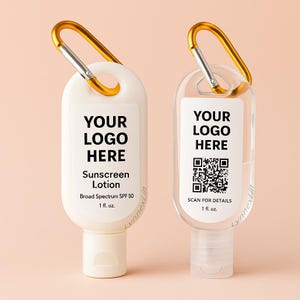 May include: Two small sunscreen lotion bottles with gold carabiner clips. One is white with the text "YOUR LOGO HERE" and "Sunscreen Lotion". The other is clear with the text "YOUR LOGO HERE" and a QR code. Both bottles are 1 fl. oz.