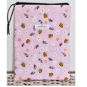 May include: A pink quilted fabric case with a black zip and pull. The case features a pattern of bees, white daisies, and small red flowers. The text "LelenCrafts" is printed on a white label.