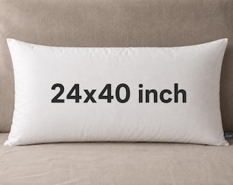 May include: A rectangular white pillow featuring the text 24x40 inch printed in black across the center. The pillow has a smooth, solid white fabric cover and a small dark blue brand tag attached to the bottom right corner of the item.
