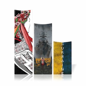 May include: Three vertical banners with different designs. The left banner features a woman wearing a traditional Ukrainian embroidered shirt and a wreath of flowers. The middle banner shows a ship sailing through a stormy sea. The right banner is blue and yellow with the text "We are Ukraine".