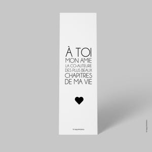 Peut inclure: Signet noir et blanc avec le texte "À TOI MON AMIE LA CO-AUTEURE DES PLUS BEAUX CHAPITRES DE MA VIE" et un cœur noir.