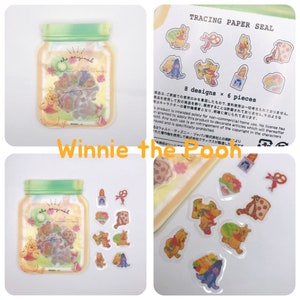 May include: A set of 8 Winnie the Pooh tracing paper stickers in a clear jar. The stickers feature Winnie the Pooh, Piglet, Tigger, and Eeyore. The jar has a green lid and a yellow label that says "the original".
