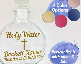 Puede incluir: Botella de agua bendita de vidrio transparente con una inscripción dorada que dice "Holy Water", una cruz dorada, "Beckett Xavier" y "Baptized 5/18/2025".