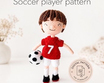 May include: A crocheted doll of a soccer player with brown hair, wearing a red jersey with the white number 7, white shorts, and black shoes, holding a black and white soccer ball. The text Soccer player pattern and Digital pattern PDF appear.