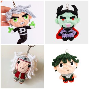 May include: Four handmade crochet keychains featuring cartoon characters. The keychains include a character with gray hair and green hands, a green-skinned devil with a red cape, a character with white hair and a red outfit, and a character with green hair.