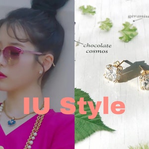 May include: The image showcases a woman wearing pink-tinted sunglasses and a necklace. The text "IU Style" is displayed in the image. On the right, a pair of square-cut, gold-colored earrings with clear stones are displayed.
