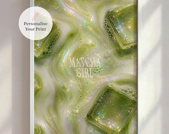 May include: A framed print featuring a close-up of a matcha drink with ice cubes. The drink has a swirling, milky green appearance with the text "Matcha Girl" in the center. A white frame surrounds the image.