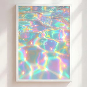 May include: A framed art print featuring an abstract, iridescent design. The artwork depicts a shimmering, water-like surface with vibrant hues of blue, green, and yellow, and the text "PISCES ENERGY". The print is encased in a white frame.