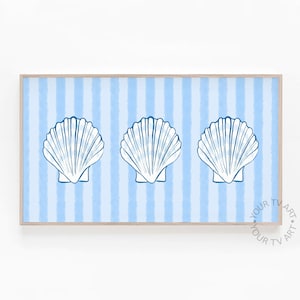 May include: A framed print featuring three white seashell illustrations on a light blue striped background. The seashells are outlined in dark blue. The frame is a light wood color. The words "YOUR TV ART" are in the bottom right corner.