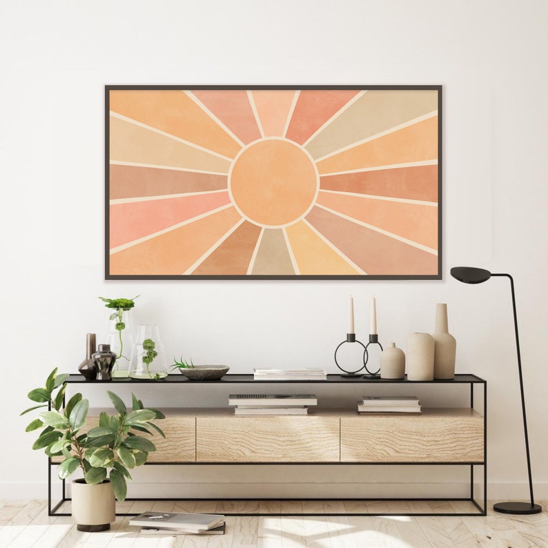 Puede incluir: Una impresi&oacute;n digital de un dise&ntilde;o de rayos de sol en tonos naranja, melocot&oacute;n y beige. Los rayos de sol est&aacute;n centrados alrededor de un c&iacute;rculo grande en un tono naranja m&aacute;s claro.
