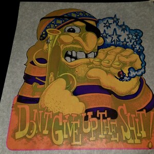 May include: A vintage psychedelic poster featuring a cartoon pirate with a bandana and an eyepatch. The pirate is holding a smoking pipe and has a cloud of smoke behind him. The poster has the text "DON'T GIVE UP THE SHIT!" in a colorful font.