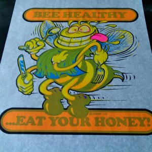 May include: A yellow and green cartoon bee with a big smile and a tongue sticking out. The bee is holding a knife and fork and has the text "BEE HEALTHY...EAT YOUR HONEY!" on the image.