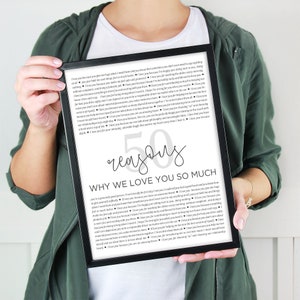 May include: A framed black and white printable with the text "50 reasons why we love you so much" and a list of reasons in a gray font. The text is in a modern, handwritten font.