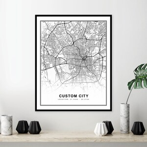 May include: Black and white city map print with the text "CUSTOM CITY" and "LOCATION: 31.9488 - 95.1778" in a black frame.