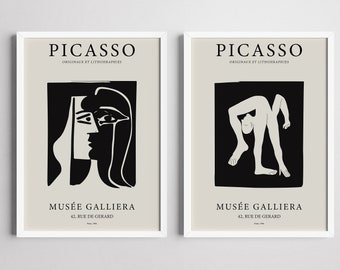 May include: Two black and white posters with a white background. The posters feature artwork by Pablo Picasso. The left poster shows a black and white line drawing of a woman's face. The right poster shows a black and white line drawing of a person bending over. Both posters have the text "PICASSO" and "MUSÉE GALLIERA" in black.
