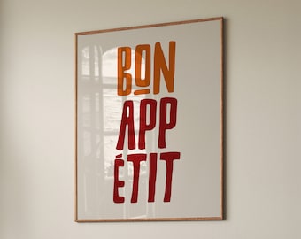 May include: A framed print with the text "BON APPÉTIT" in red and orange lettering on a white background.