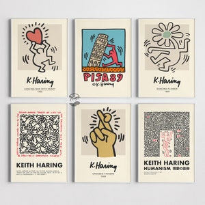 May include: A collection of six framed art prints displaying the vibrant pop art of Keith Haring. The prints feature his distinctive figures and bright colours, including a dancing man with a heart, a Pisa 89 design, and crossed fingers. Each print is in a neutral frame.