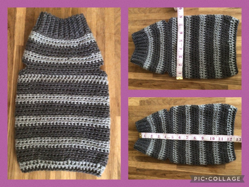 May include: A gray and white striped crocheted dog sweater with armholes. The sweater is laid flat on a wooden surface with a measuring tape next to it.