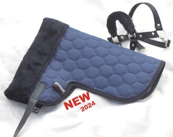 May include: A navy blue quilted saddle pad with a black trim and a black fuzzy edge. The pad has a honeycomb pattern and a leather strap. A black halter is also visible. The text "NEW 2024" is in the image.