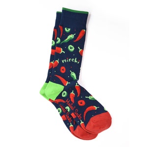 May include: A pair of blue socks with a green and red chilli pepper pattern. The socks have the text "Halal Socks" and "mirchi" printed on them.