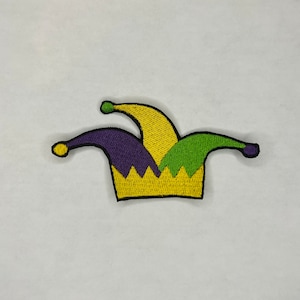 May include: An embroidered jester hat patch in yellow, green and purple.