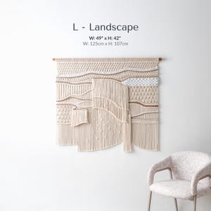 Large landscape-oriented boho macrame wall art measuring 49 by 42 inches. The handmade fiber art features dynamic, asymmetrical waves of textured knots and thick, flowing fringe.