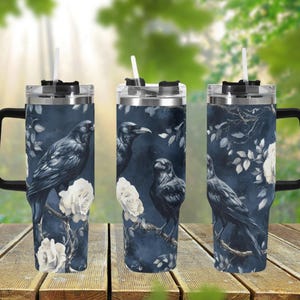 May include: Three stainless steel tumblers with a black crow and white rose design. The tumblers have a black lid and a black handle.