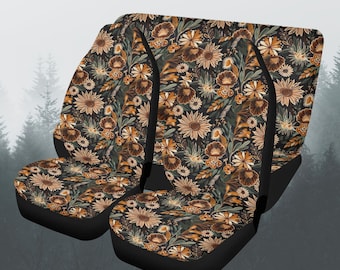 May include: Set of four car seat covers with a floral pattern featuring sunflowers, daisies, and other flowers in shades of brown, yellow, and green on a black background.