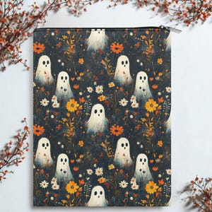 May include: A rectangular, zippered pouch featuring a repeating pattern of white ghost figures amidst orange and yellow flowers and foliage on a dark blue background. The design has a whimsical, Halloween theme.
