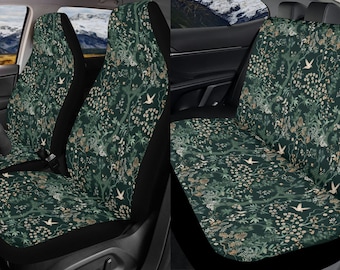 May include: A pair of car seat covers with a dark green background and a floral pattern featuring white and beige birds. The covers are made of a soft, comfortable fabric and are designed to protect your car seats from dirt and wear.
