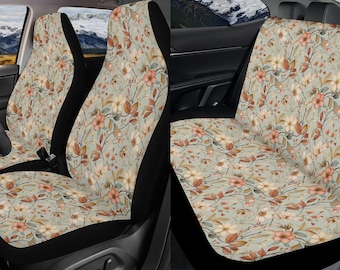 May include: A set of two car seat covers with a floral pattern. The covers are beige with brown and pink flowers and leaves. The covers are made of a soft, comfortable fabric and are easy to install.